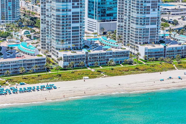 drone / aerial view with a water view and a beach view