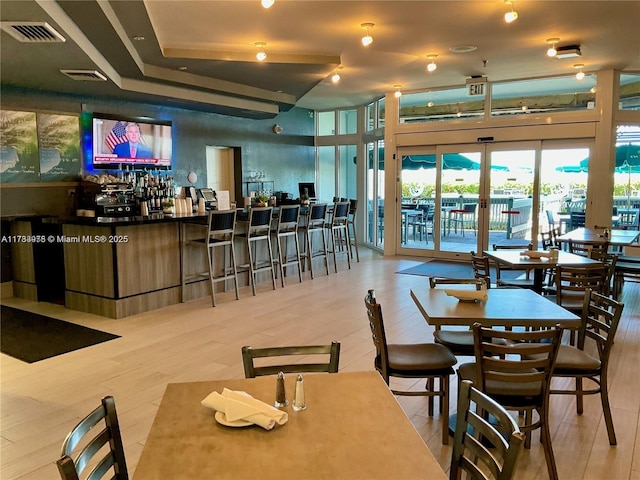 dining space featuring visible vents and wood finished floors