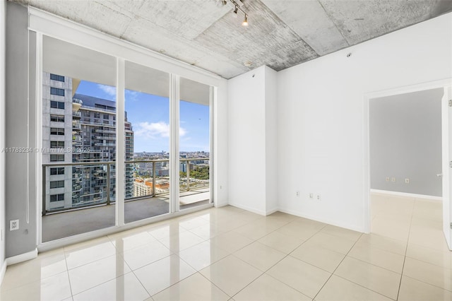 3470 E Coast Ave Unit H2706, Miami, FL 33137 - tiled spare room with a city view, baseboards, and expansive windows