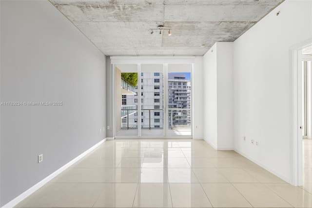 3470 E Coast Ave Unit H2706, Miami, FL 33137 - tiled empty room featuring baseboards