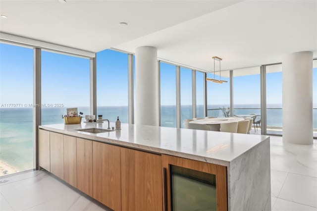 2000 S Ocean Dr Unit 28A, Hallandale Beach, FL 33009 - kitchen with a sink, beverage cooler, a water view, modern cabinets, and a wall of windows
