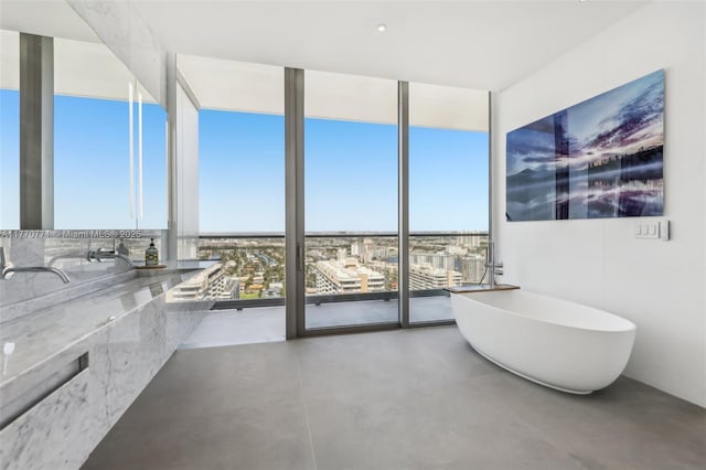 2000 S Ocean Dr Unit 28A, Hallandale Beach, FL 33009 - full bath with a soaking tub, expansive windows, and concrete floors