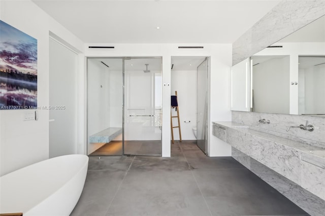 2000 S Ocean Dr Unit 28A, Hallandale Beach, FL 33009 - full bath featuring visible vents, toilet, a walk in shower, concrete floors, and a freestanding tub