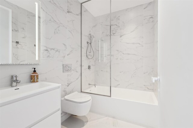 2000 S Ocean Dr Unit 28A, Hallandale Beach, FL 33009 - bathroom with toilet, tile walls, marble finish floor, washtub / shower combination, and vanity