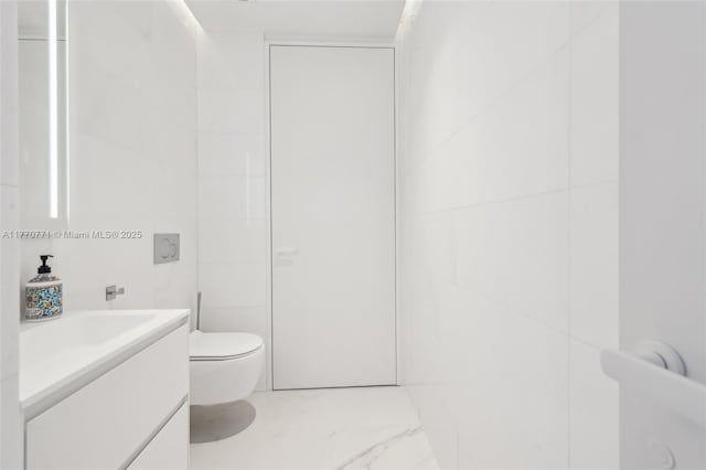 2000 S Ocean Dr Unit 28A, Hallandale Beach, FL 33009 - half bath with marble finish floor, toilet, vanity, and tile walls