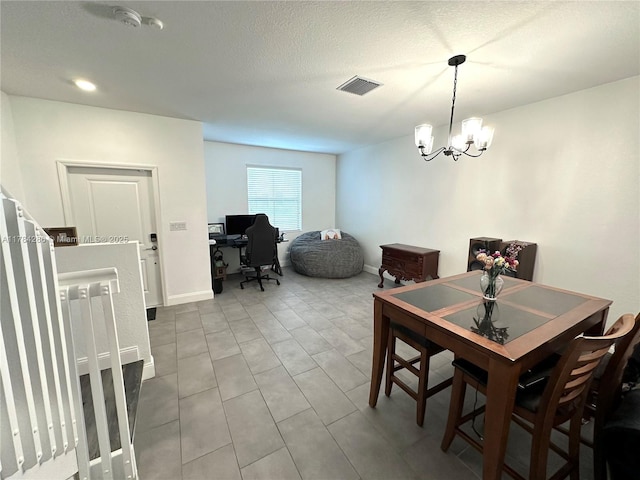 dining space with visible vents, baseboards, and a chandelier