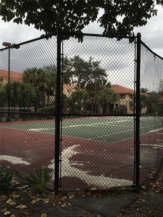 view of sport court featuring fence