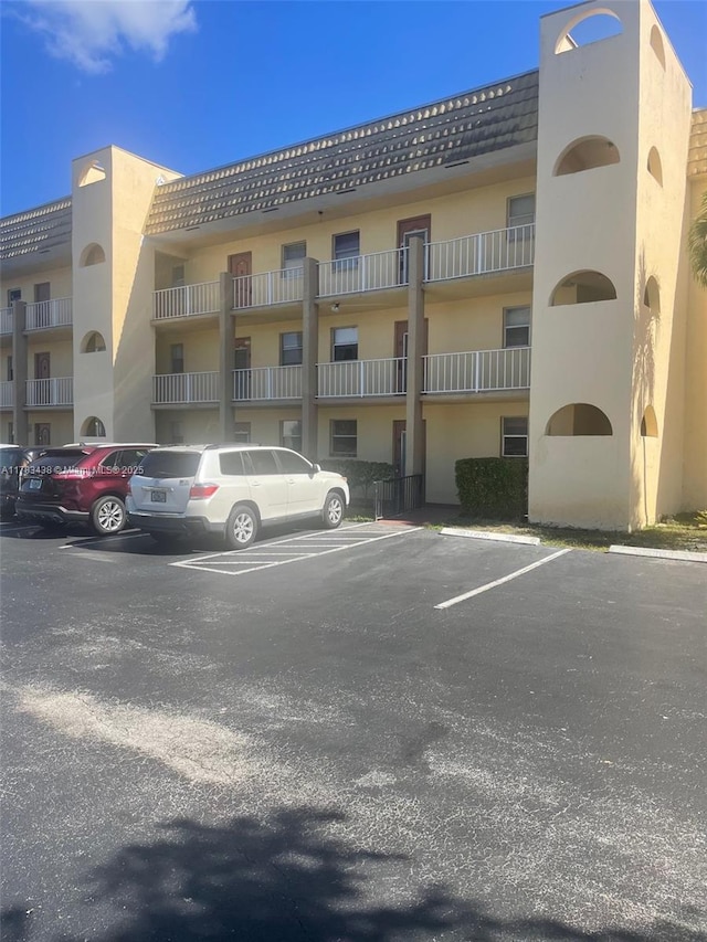 view of building exterior featuring uncovered parking