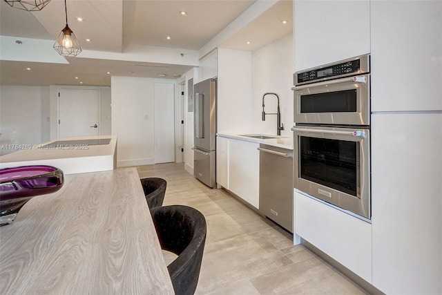 20191 E Country Club Dr Unit 802, Aventura, FL 33180 - kitchen featuring stainless steel appliances, recessed lighting, white cabinetry, and a sink