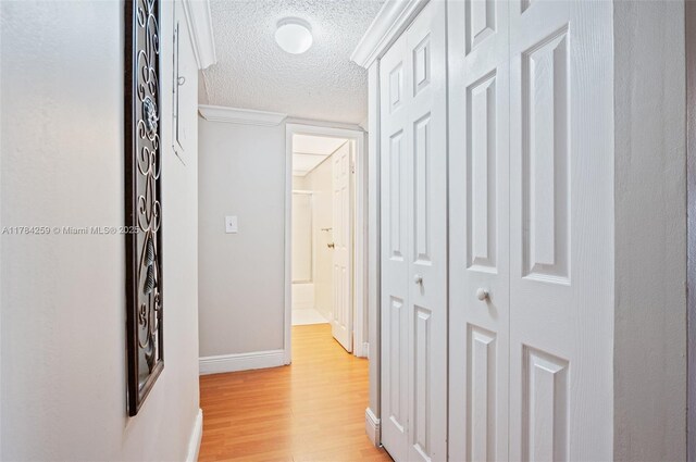 3000 Riverside Dr Unit 309-1, Coral Springs, FL 33065 - hallway featuring light wood-type flooring, baseboards, and a textured ceiling