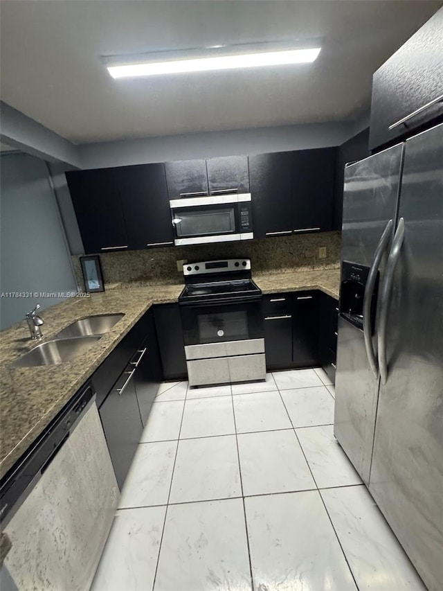 5955 NW 25th Ct Unit 208, Sunrise, FL 33313 - kitchen with appliances with stainless steel finishes, dark cabinets, backsplash, light tile patterned floors, and stone countertops