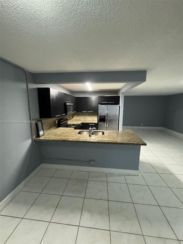 5955 NW 25th Ct Unit 208, Sunrise, FL 33313 - kitchen with stainless steel refrigerator with ice dispenser, range with electric stovetop, a textured ceiling, a peninsula, and stone countertops