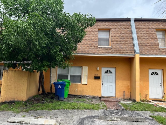 5955 NW 25th Ct Unit 208, Sunrise, FL 33313 - multi unit property with a shingled roof, stucco siding, and mansard roof