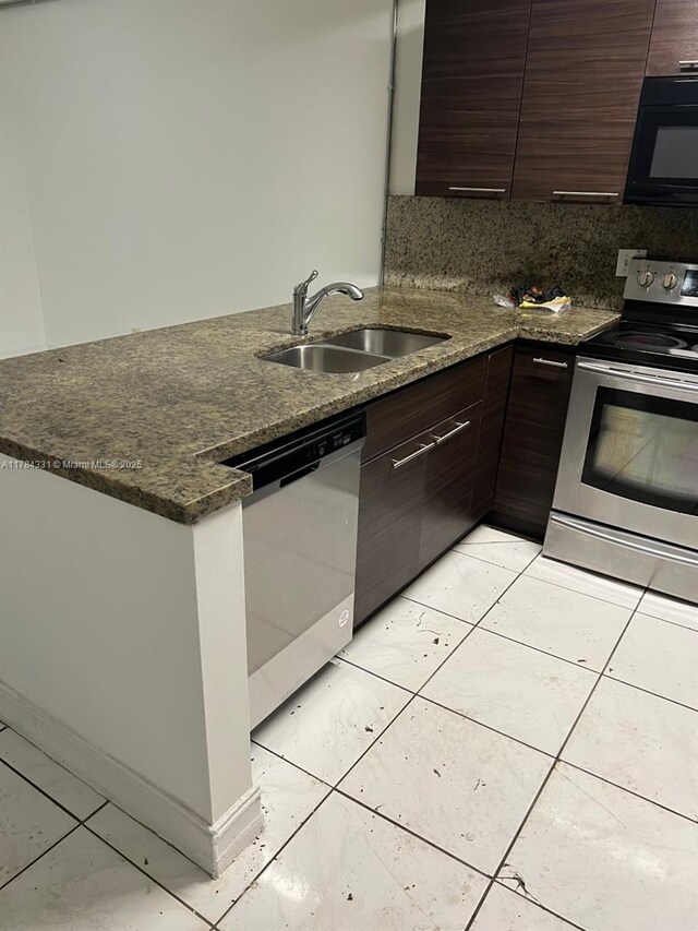 5955 NW 25th Ct Unit 208, Sunrise, FL 33313 - kitchen featuring appliances with stainless steel finishes, a peninsula, dark brown cabinets, and tasteful backsplash