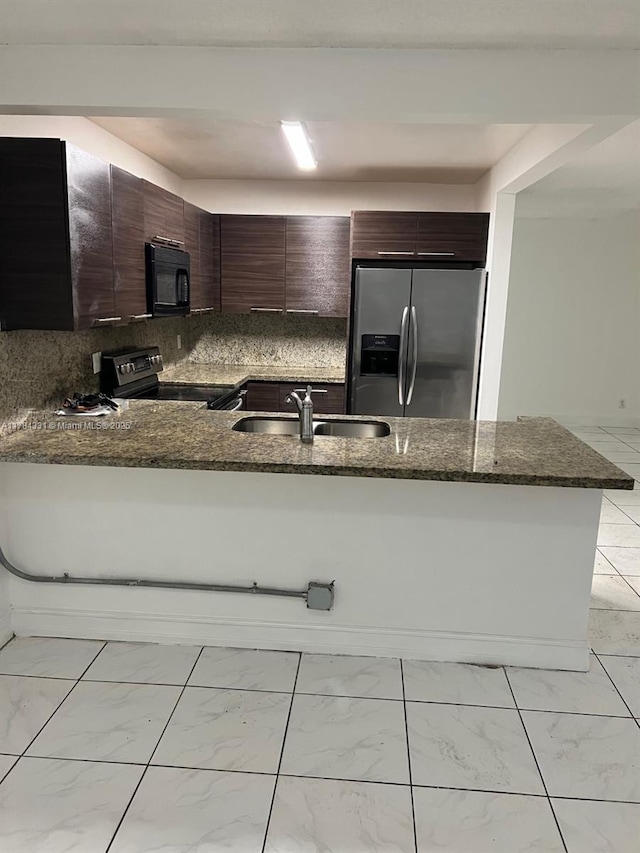 5955 NW 25th Ct Unit 208, Sunrise, FL 33313 - kitchen with stainless steel appliances, light marble finish flooring, a peninsula, and dark stone countertops