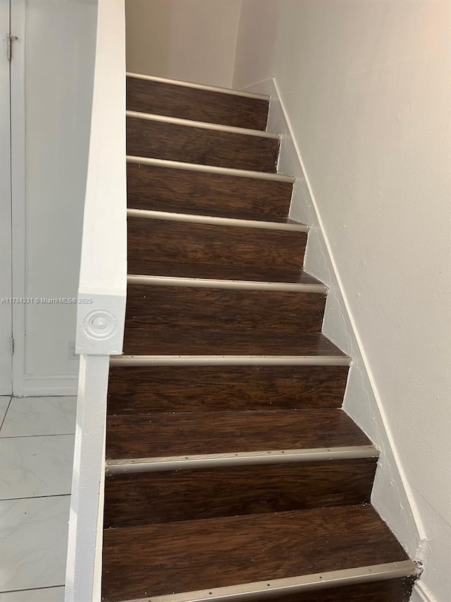 5955 NW 25th Ct Unit 208, Sunrise, FL 33313 - staircase featuring marble look tile flooring