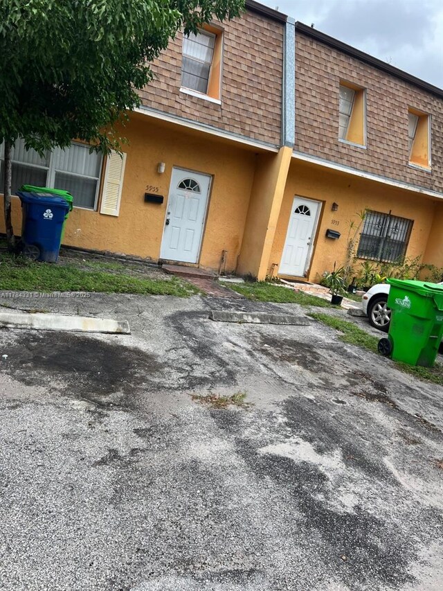 5955 NW 25th Ct Unit 208, Sunrise, FL 33313 - multi unit property with mansard roof, stucco siding, and a shingled roof