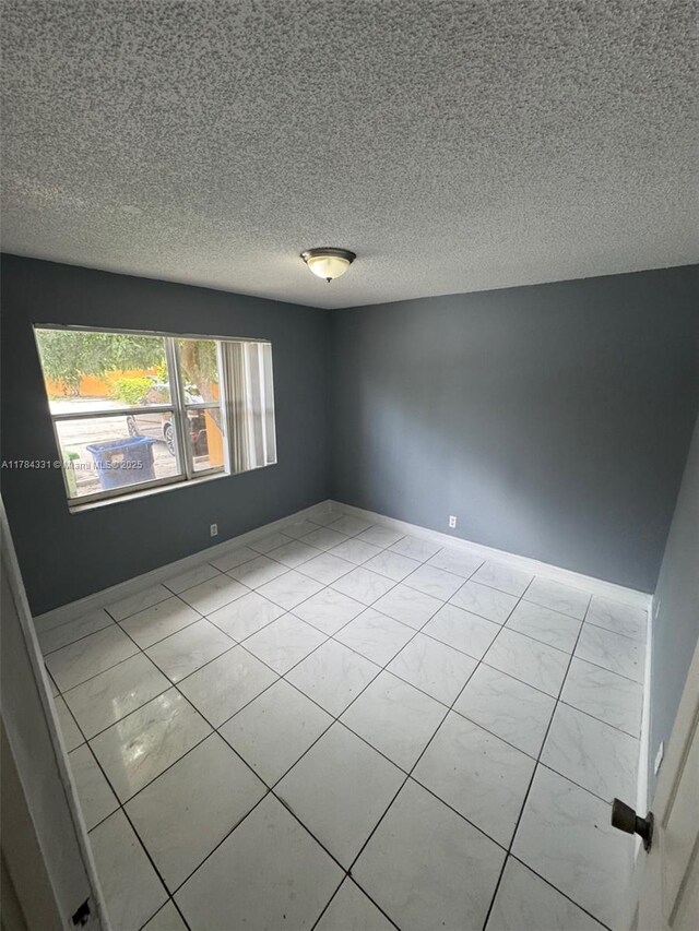 5955 NW 25th Ct Unit 208, Sunrise, FL 33313 - spare room featuring a textured ceiling and baseboards