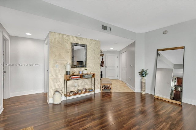 interior space with wood finished floors, baseboards, visible vents, and recessed lighting