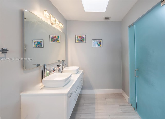1000 NE 204th Ln, Miami, FL 33179 - bathroom with a skylight, a sink, visible vents, and double vanity