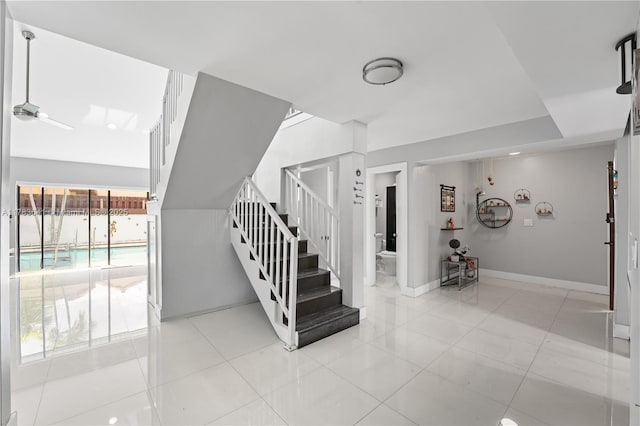 1000 NE 204th Ln, Miami, FL 33179 - staircase with baseboards and tile patterned flooring