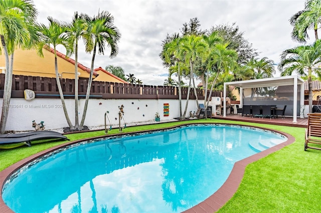 1000 NE 204th Ln, Miami, FL 33179 - view of pool featuring a fenced backyard, a wooden deck, a yard, and a fenced in pool