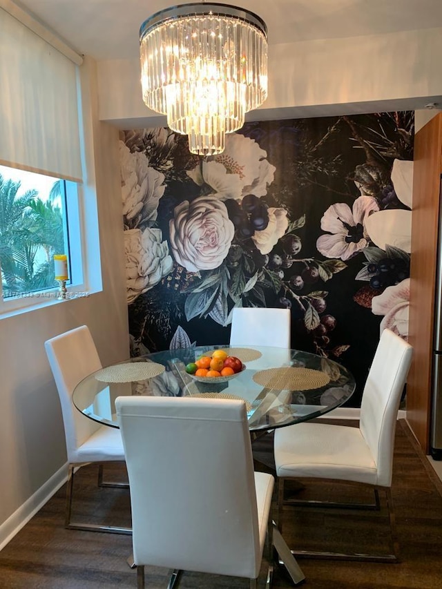 dining room with baseboards, a chandelier, and wood finished floors