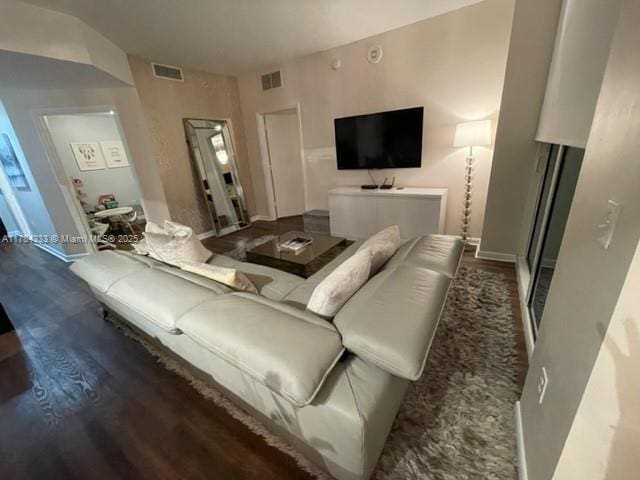 living room featuring visible vents and wood finished floors