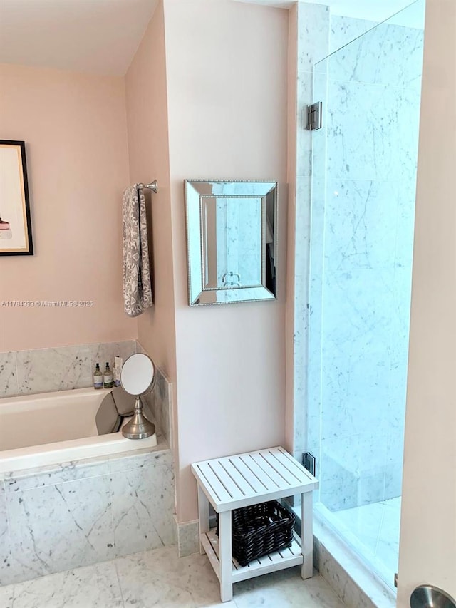 full bath with a shower stall and a garden tub