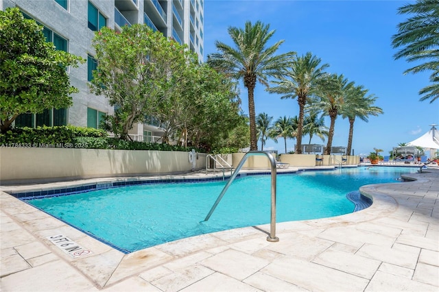 community pool with a patio area