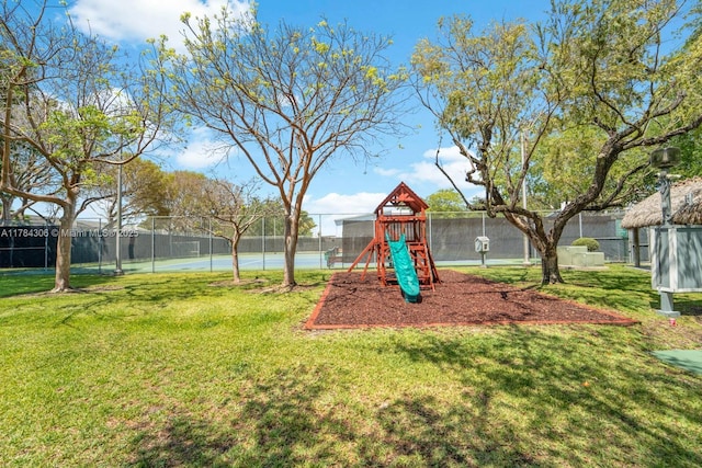 communal playground with a yard and fence