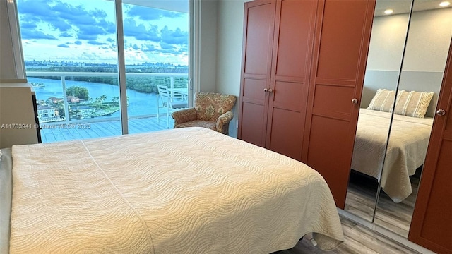 400 SE Sunny Isles Blvd Unit 1702, Sunny Isles Beach, FL 33160 - bedroom with a closet, wood finished floors, and a water view