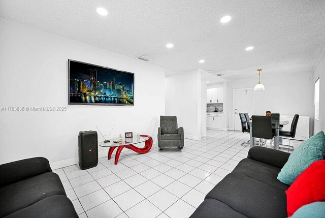 5080 E 5th Ave, Hialeah, FL 33013 - living room featuring a textured ceiling, recessed lighting, and light tile patterned floors