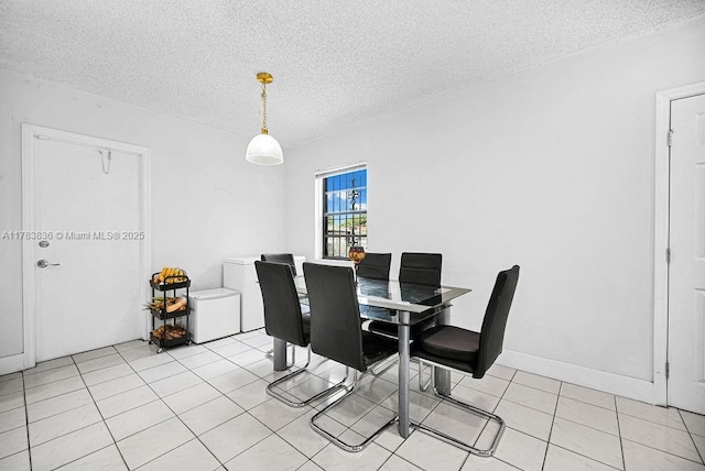 5080 E 5th Ave, Hialeah, FL 33013 - dining area with a textured ceiling and light tile patterned flooring