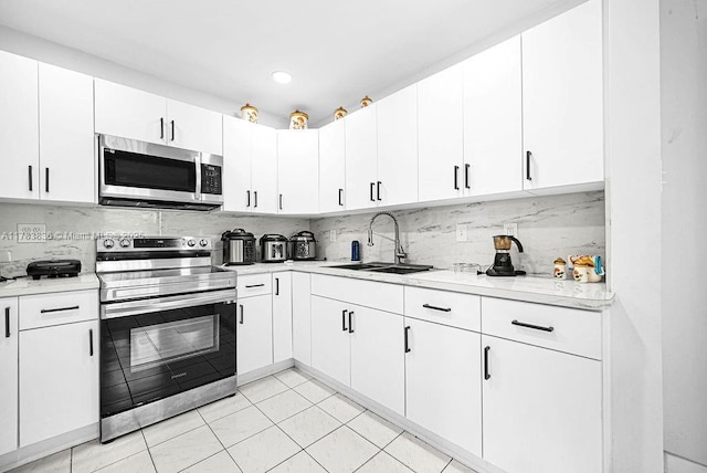 5080 E 5th Ave, Hialeah, FL 33013 - kitchen featuring stainless steel appliances, light countertops, backsplash, white cabinetry, and recessed lighting
