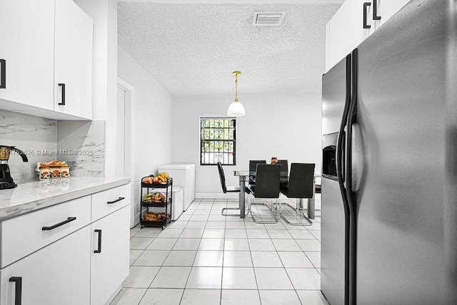 5080 E 5th Ave, Hialeah, FL 33013 - kitchen with stainless steel refrigerator with ice dispenser, white cabinetry, a textured ceiling, light tile patterned floors, and hanging light fixtures