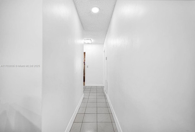5080 E 5th Ave, Hialeah, FL 33013 - hallway featuring recessed lighting, light tile patterned flooring, and a textured ceiling