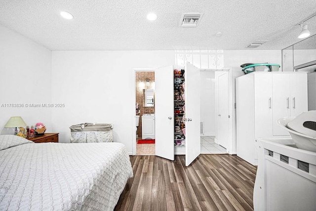 5080 E 5th Ave, Hialeah, FL 33013 - bedroom featuring wood finished floors, a textured ceiling, ensuite bath, and recessed lighting