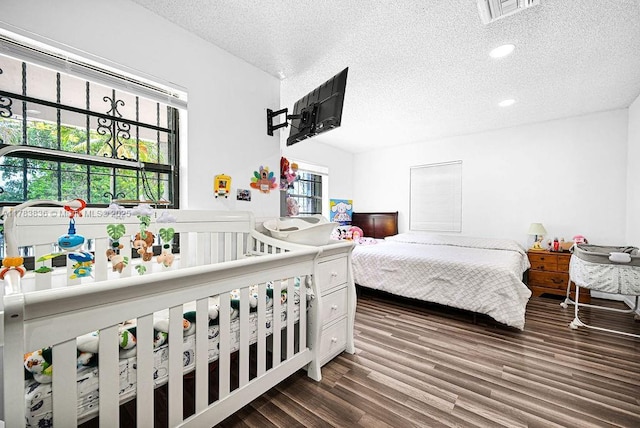 5080 E 5th Ave, Hialeah, FL 33013 - bedroom featuring a textured ceiling, dark wood-type flooring, and recessed lighting