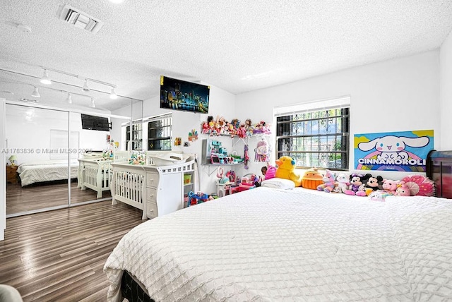 5080 E 5th Ave, Hialeah, FL 33013 - bedroom with a textured ceiling and wood finished floors