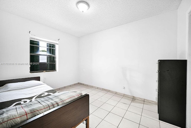 5080 E 5th Ave, Hialeah, FL 33013 - bedroom featuring a textured ceiling and light tile patterned floors