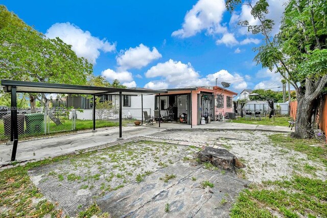5080 E 5th Ave, Hialeah, FL 33013 - rear view of house with a fenced backyard and a patio
