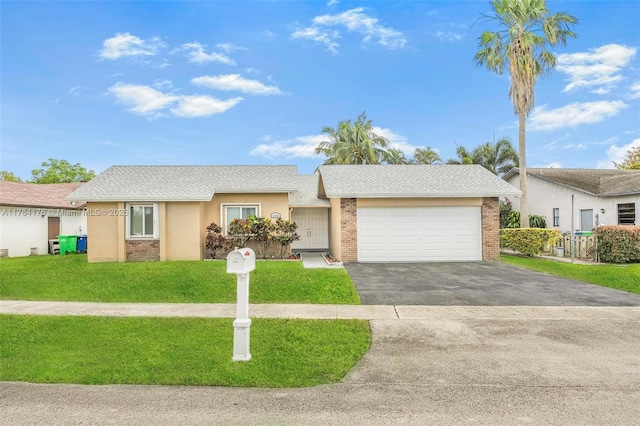 ranch-style home featuring an attached garage, aphalt driveway, a front lawn, and brick siding