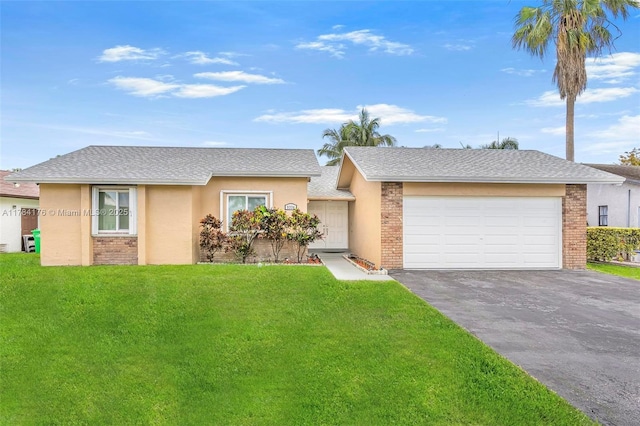 single story home with a front yard, brick siding, a garage, and aphalt driveway