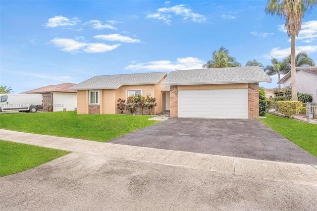 single story home featuring a front yard, an attached garage, driveway, and stucco siding