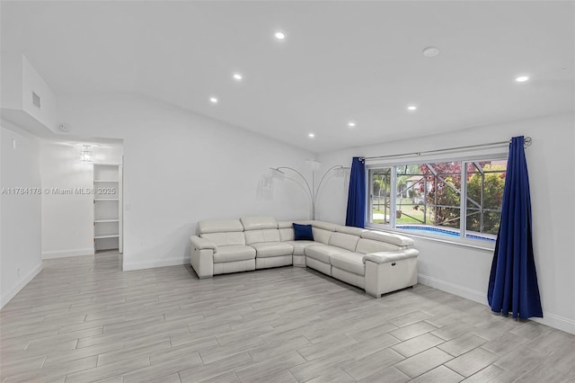 living room featuring baseboards, light wood finished floors, and recessed lighting