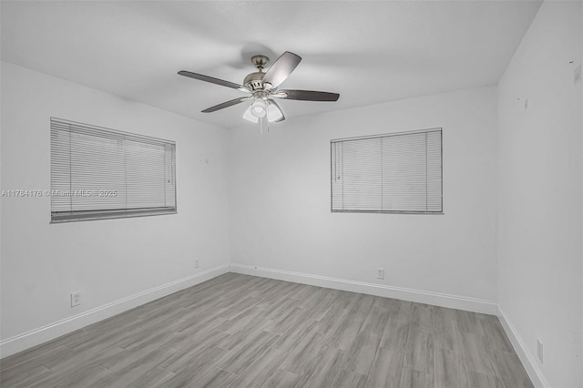 unfurnished room with light wood-style floors, ceiling fan, and baseboards