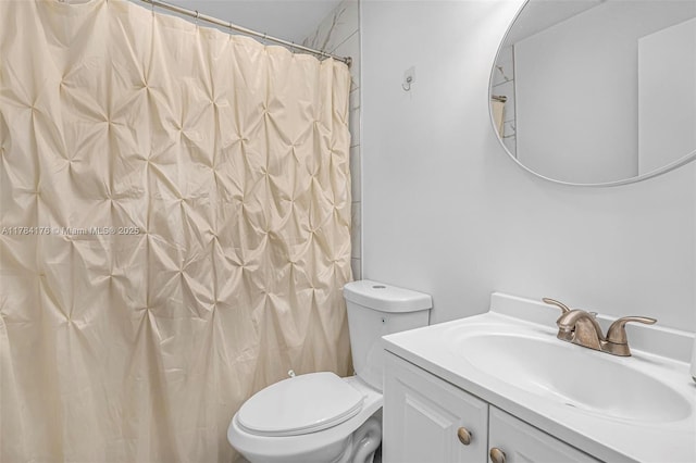 bathroom with toilet, curtained shower, and vanity