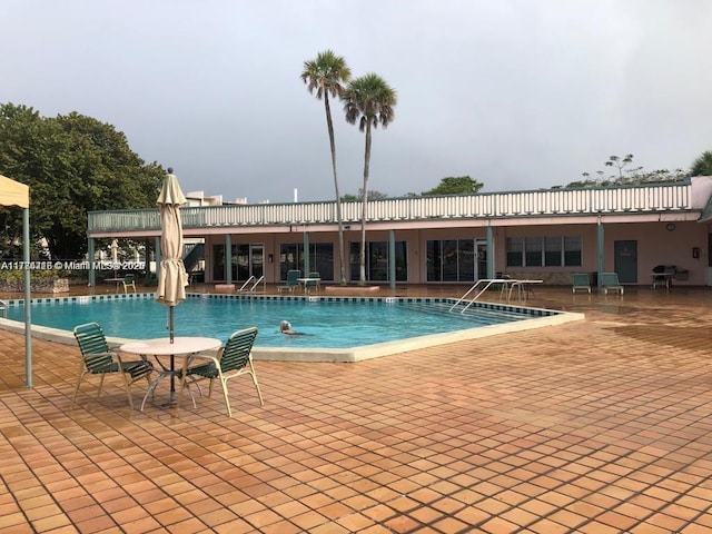 pool featuring grilling area and a patio