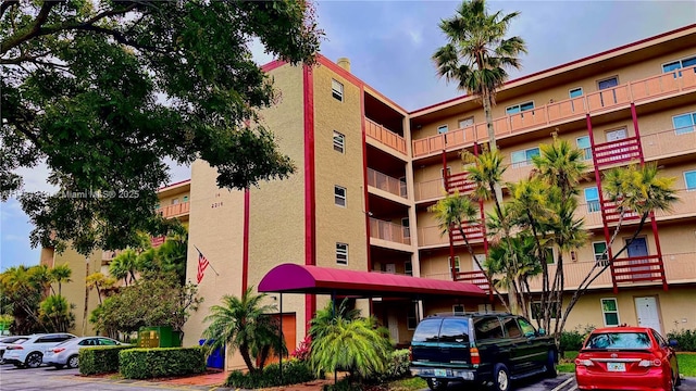 2216 N Cypress Bend Dr Unit 501, Pompano Beach, FL 33069 - view of apartment building / complex featuring uncovered parking